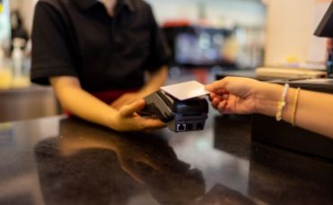 Handing credit card to front desk team member